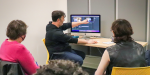A Digital Navigator instructs a class about video editing.